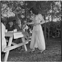 Claudia Martinez pours a cup of coffee for Ed Hackley during Anaheim's annual Halloween festival, Anaheim, October 31, 1946