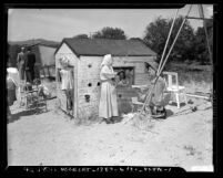 Norma Jean Burke talking to children of cult members at Henry C. Newson Ranch in La Habra, Calif., 1948