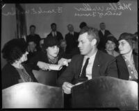 Frank E. Walker, father of murder victim Frances Walker, sits in a crowded room, Los Angeles, 1935