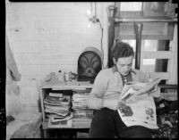 Man reads a newspaper at the Unemployed Citizens' League of Santa Monica, 1930s