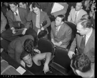 Wrestler Jules Strongbow after being knocked out of the ring at the Olympic, Los Angeles, 1937