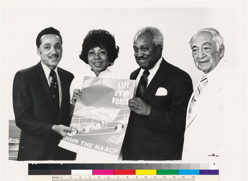 Elbert Hudson, unidentified woman, Leonard H. Carter, H. Claude Hudson (left to right) with poster for membership campaign