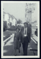 Aldous and Maria Huxley, walking on sidewalk, Los Angeles [descriptive]