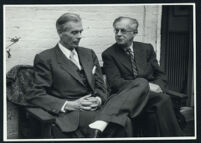 Aldous and Julian Huxley seated, talking (1) [descriptive]