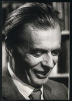 Aldous Huxley portrait, looking down, smiling [descriptive]