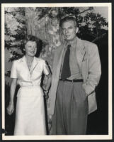 Aldous and Laura Huxley standing in front of a tree, Los Angeles, 1956 [descriptive]