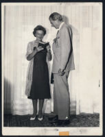 Aldous Huxley with Laura Huxley holding a book [descriptive]