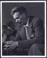 Aldous Huxley seated, looking down, hands clasped, circa 1948 [descriptive]