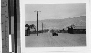 Truck traveling along the main road of the Japanese Relocation Camp, Manzanar, California, ca. 1944