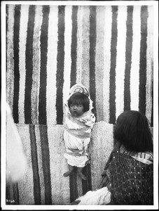 Walapai Indian papoose with mother looking on, Hackbury, Arizona, ca.1900