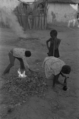 Children playing with a small fire in the street, San Basilio de Palenque, ca. 1978