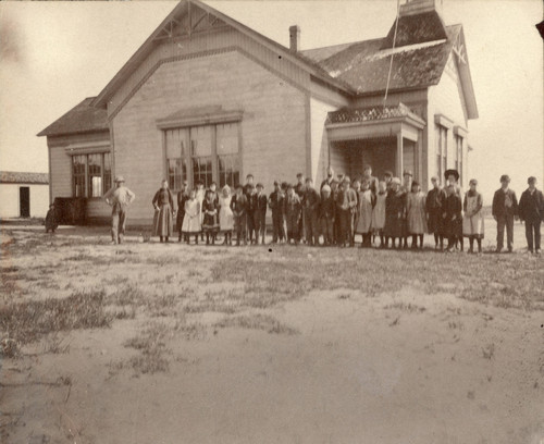 Mounted photograph of one of Banning, California's first schoolhouses located on the east side of Murray Street