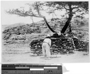 Man mourning before a pagan shrine, Korea, ca. 1920-1940