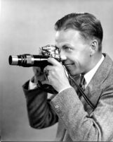 Thelner Hoover - Portrait taking photograph, c.1935