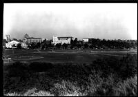 Distant view of baseball game with campus in background, 1946