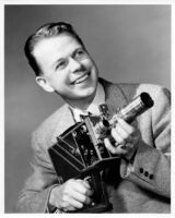 Thelner Hoover - Portrait holding large camera, c.1935