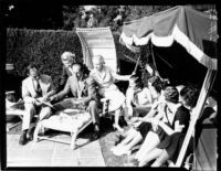 George and Ira Gershwin with students lounging in the sun, 1937