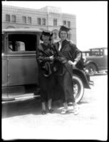 Two female students in commencement gowns, c.1930