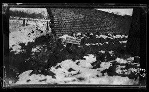 View of a warning sign near a damaged wall in France during World War I, ca.1916