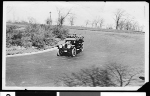 Automobile passengers on an unidentified road, part of the Boulevard System in Kansas City, Missouri, ca.1910