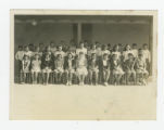 Group of Nisei 7th graders with a teacher outside a barrack