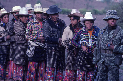Mayan men in line to vote and a soldier, Sololá, 1982