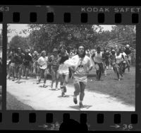 People participating in run during the Jim Thorpe Memorial Pow Wow and Games at Whittier Narrows Recreation Area, Calif., 1984