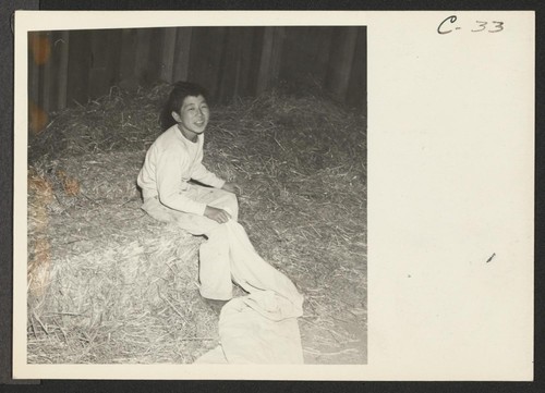 This youngster is preparing to fill a mattress-cover with straw after arriving at the relocation center for evacuees of Japanese ancestry on the Colorado River Indian Reservation. Photographer: Clark, Fred Poston, Arizona