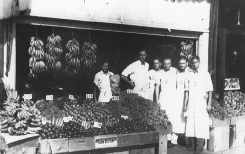 Group portrait of produce workers in market on South Glassell Street, Orange, California, 1927