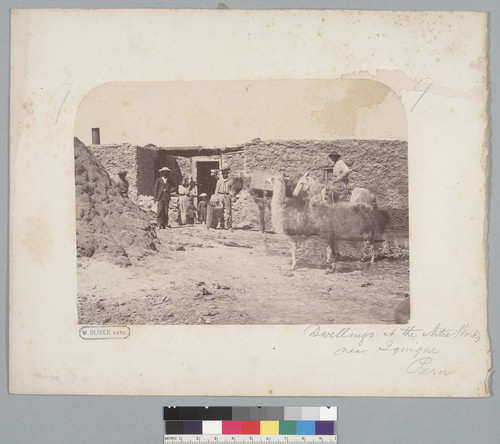 "Dwellings at the nitre works near Iquique, Peru [Chile]," with men, women and children. [photographic print]