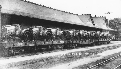 Santa Fe Depot with railroad car loaded with shipment of tractors for the M. Eltiste Company, Orange, California, 1922