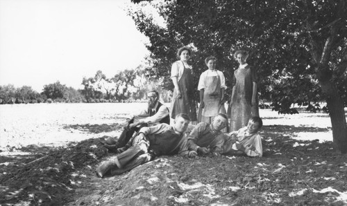Hillebrecht Ranch with apricot pickers and pitters posed in the shade by an apricot tree, Orange, California, 1910