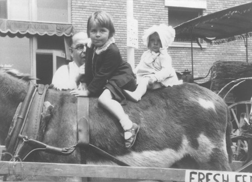 May Day Festival with Mary Ann Lentz and Nancy Ann Talmage sitting on a donkey, Orange, California, 1933