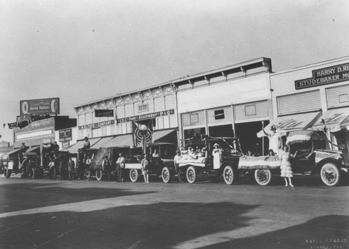 Trucks from the M. Eltiste & Company lined up along the 100 block of North Glassell Street, Orange, California, ready for a parade, ca. 1922