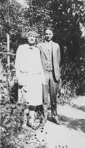 Alice Clark and husband Laurence Pitcher standing in a garden, Orange, California, 1927