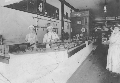 Enright Butcher Shop interior with employees Emil H. Sohre and Carl S. Kinney, Orange, California, 1922-1924