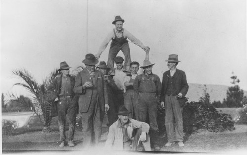 Men forming a human pyramid in Hewes Park, El Modena, California