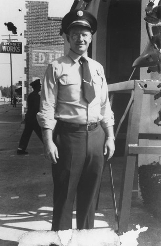 Edwin Quandt standing next to Orange Fire Station on Olive Street, Orange, California, ca. 1950