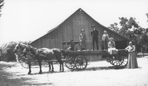 Hillebrecht family members pose with hay wagon at the family's ranch in Orange, California, 1908