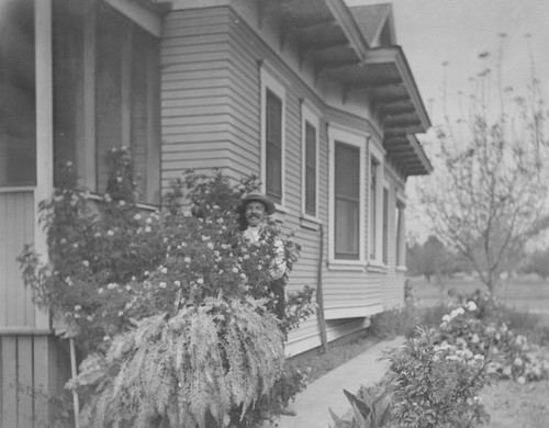 Alfred Higgins standing next to his home on North Orange Street, Orange, California, ca. 1905