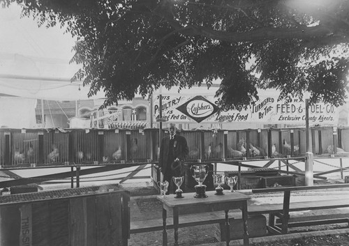 1910 Street Fair with James Fullerton in front of his poultry exhibit, Orange, California