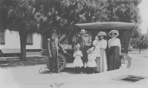 C.A. Franzen family with automobile in J. Schmetgen yard, Orange, California, 1911