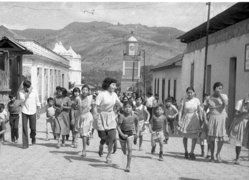 Mayan people moving through a neighborhood, Guatemela City, 1982