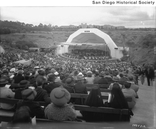 An audience at the amphitheater in Balboa Park listening to a multiple piano recital