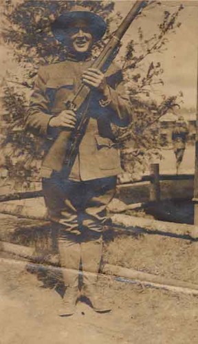 Jules Balangue in soldier's uniform w/rifle