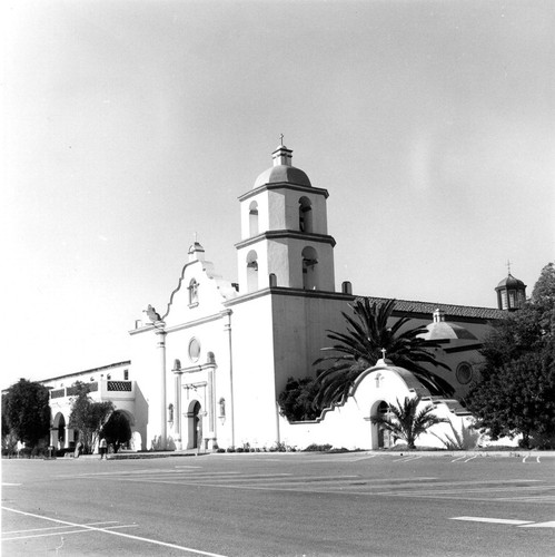 Mission San Luis Rey mission façade from right showing entrance to garden and cemetery in San Diego County, CA