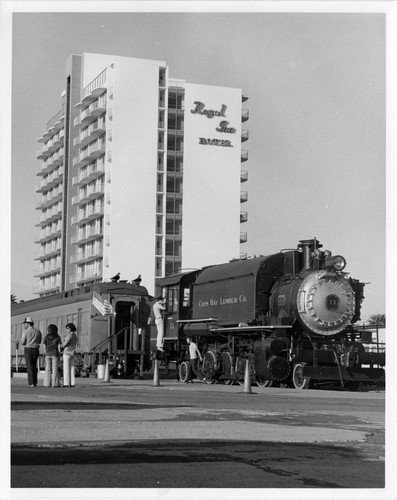 Royal Inn Hotel with train in foreground in San Diego, CA