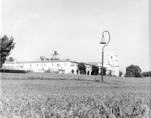 Mission San Luis Rey mission façade and El Camino Real Bell from left in San Diego County, CA