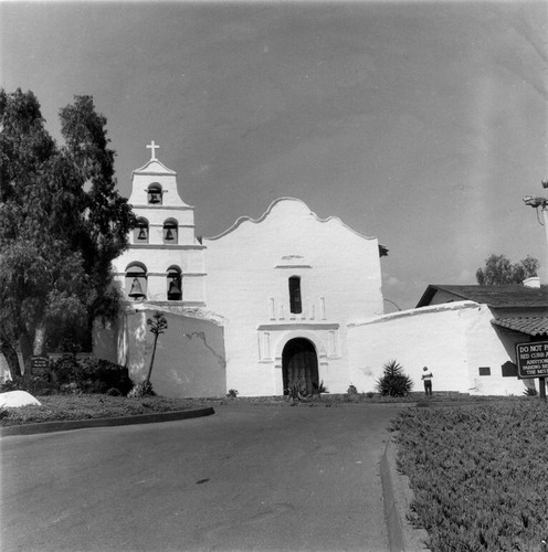 Mission San Diego De Alcala façade and entrance drive in San Diego County, CA