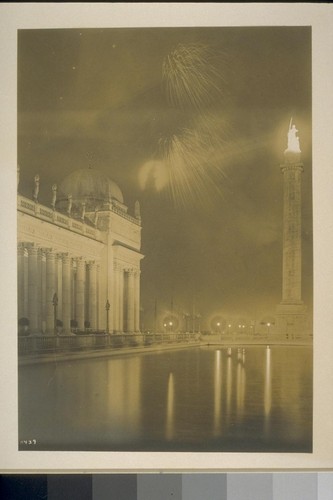 H439. [Fireworks display. From Court of the Universe. Column of Progress, at right, with "The Adventurous Bowman" (Hermon A. MacNeil, sculptor) illuminated atop.]